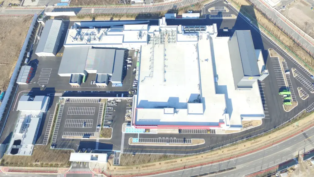 Aerial view of a greenfield slaughterhouse complex arranged around its site access roads