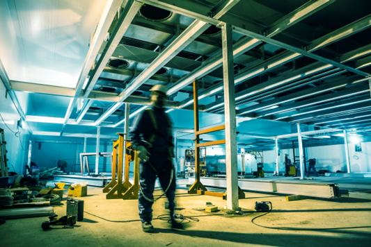 Refrigeration and process pipework being installed inside a food processing plant during construction
